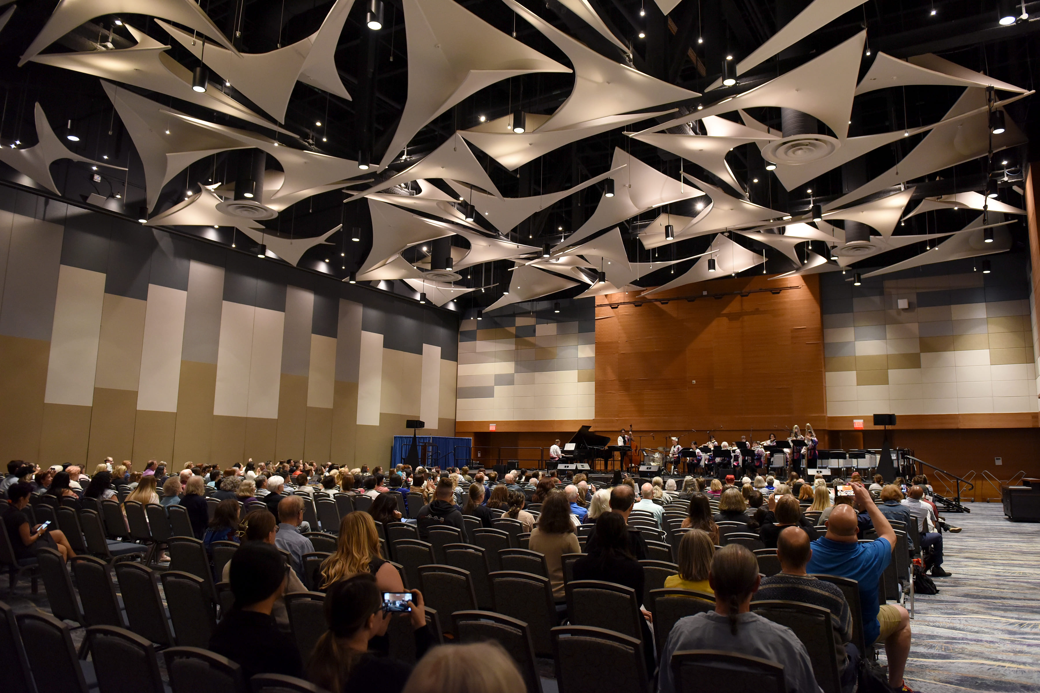 a flute ensemble performs in a concert hall