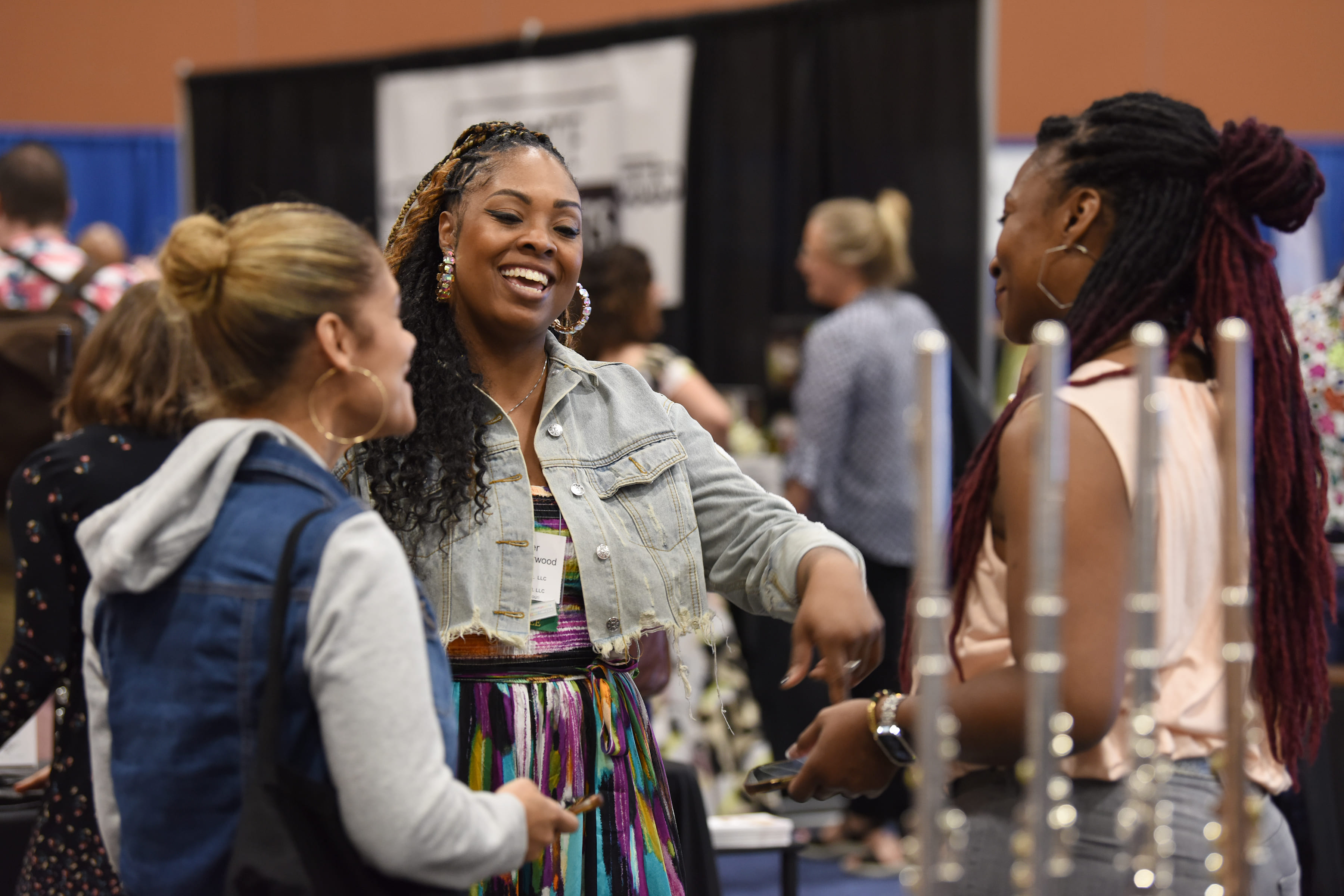 a group of people smiling in an exhibit hall