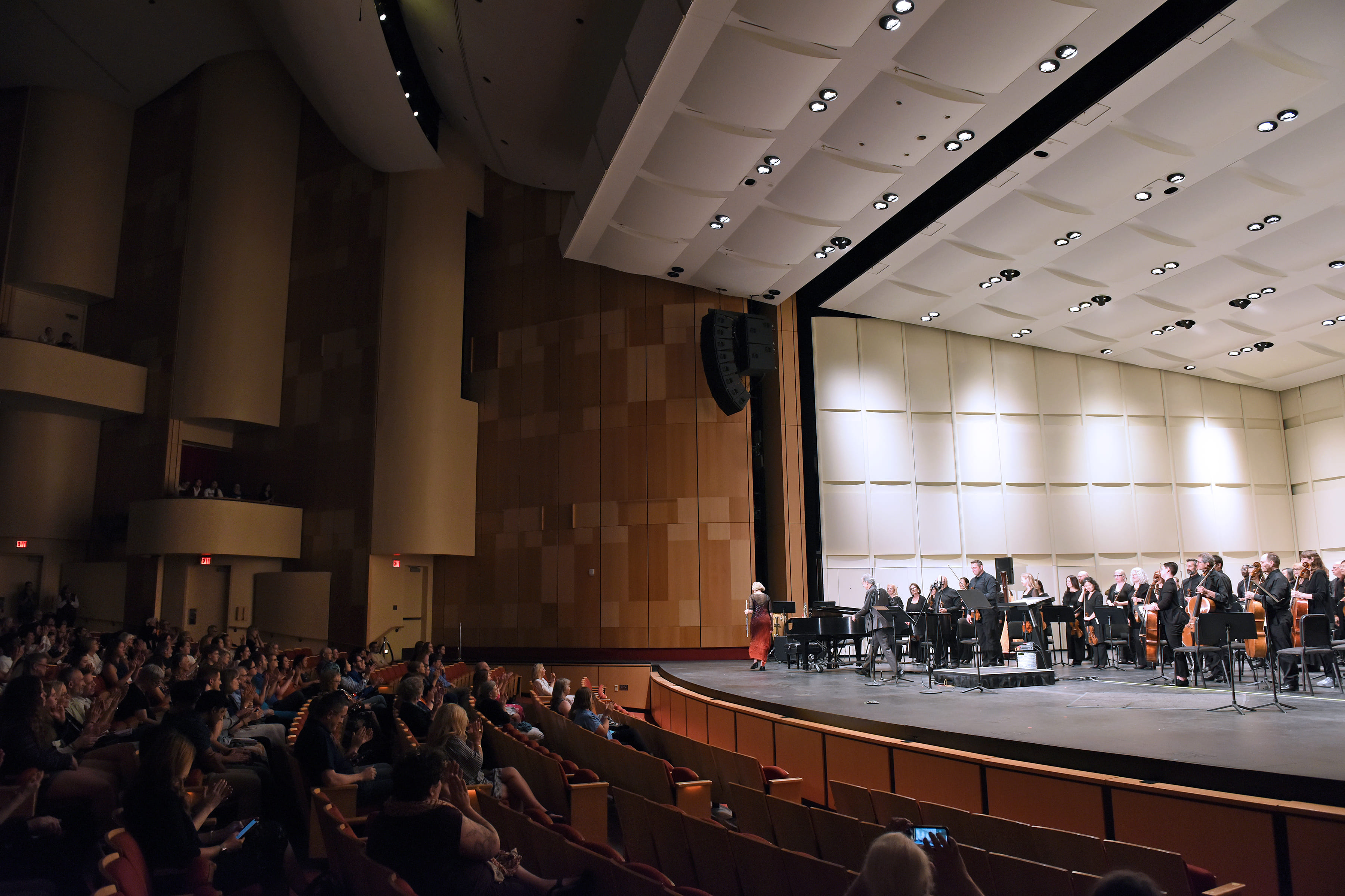 An orchestra performs in an auditorium