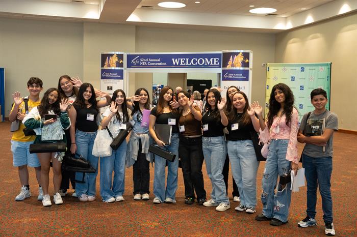 A group of young flutists pose for a photo